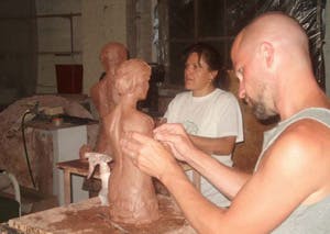 Students working with clay in a Figure sculpture class at the Fire Arts Center
