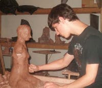 Fire Arts Center figure sculpture student sculpting in clay